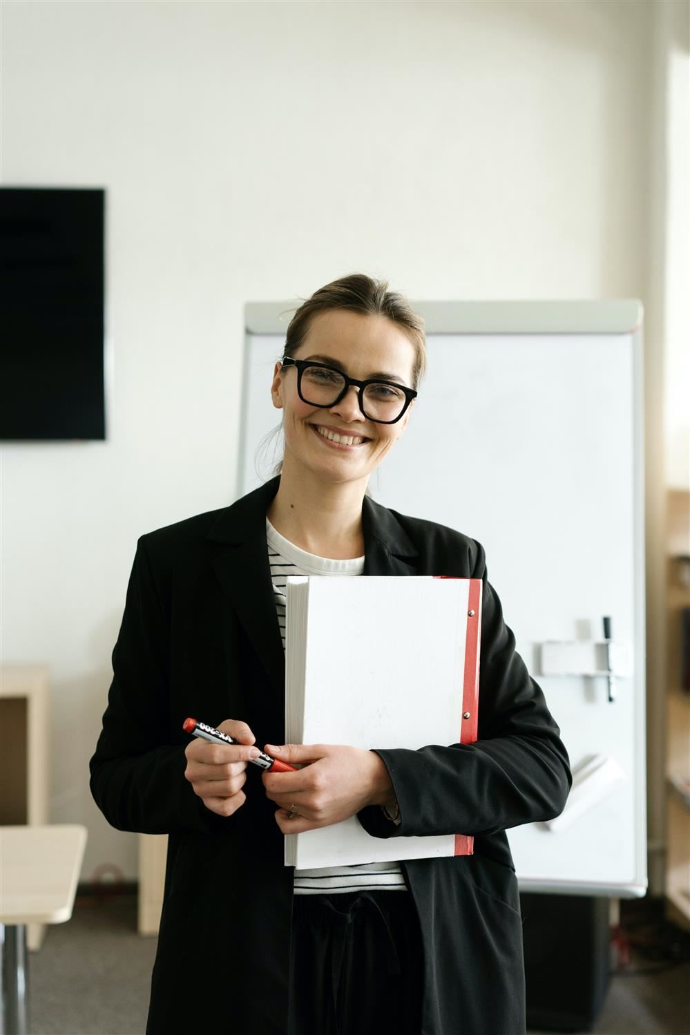 Female teacher holding notebook